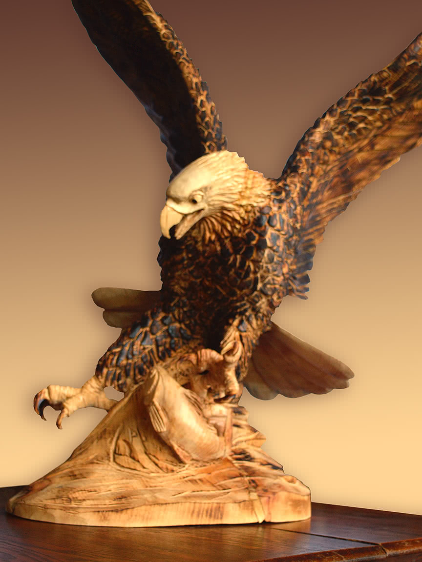 Majestic and Powerful Bald Eagle Catching Fish - carved wooden Sculpture by Paul Stark 